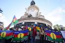 Demonstrators hold Kanak and Socialist National Liberation Front flags during a gathering in Paris on Thursday (Thomas Padilla/AP)