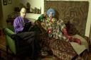 Dr Richard Wiseman (left), a psychologist, chats to a clown at the Freud Museum, as he sits on Sigmund Freud's infamous couch