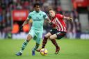 Arsenal's Alex Iwobi (left) and Southampton's Jan Bednarek battle for the ball during the Premier League match at St Mary's Stadium, Southampton. PA