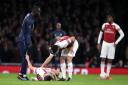 Arsenal's Laurent Koscielny (floor) lies injured as Granit Xhaka consoles him after a collision with Manchester United's Romelu Lukaku (left) during the FA Cup tie (pic John Walton/PA)