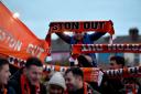 Blackpool fans outside the stadium hold up Oyston Out scarves in protest prior to the beginning of the Emirates FA Cup, third round match at Bloomfield Road, Blackpool. PA