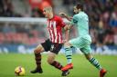 Southampton's Oriol Romeu (left) and Arsenal's Henrikh Mkhitaryan battle for the ball during the Premier League match at St Mary's Stadium, Southampton. PA