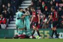 Bournemouth's Jefferson Lerma lays dejected after conceding an own goal as Arsenal players celebrate (pic John Walton/PA)