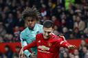 Arsenal's Alex Iwobi (left) and Manchester United's Diogo Dalot battle for the ball during the Premier League match at Old Trafford, Manchester. PA