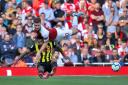 Arsenal's Shkodran Mustafi (right) and Watford's Andre Gray battle for the ball during the Premier League match at the Emirates Stadium, London.