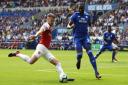 Arsenal's Aaron Ramsey (left) and Cardiff City's Sol Bamba battle for the ball during the Premier League match at the Cardiff City Stadium.