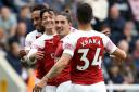 Arsenal's Mesut Ozil (second left) celebrates scoring his side's second goal of the game during the Premier League match at St James' Park, Newcastle (pic Owen Humphreys/PA)