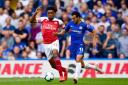 Arsenal's Alex Iwobi (left) and Chelsea's Pedro battle for the ball during the Premier League match at Stamford Bridge, London.