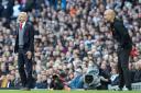 Arsenal manager Arsene Wenger (left) and Manchester City manager Pep Guardiola during the Premier League match at the Etihad Stadium, Manchester.