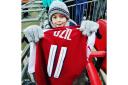 The only happy Arsenal fan this week - Albie Best with Mesut Ozil's match shirt after the 3-0 defeat by Manchester City in the Carabao Cup final at Wembley