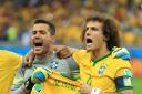 Brazil goalkeeper Julio Cesar and Brazil's David Luiz (right) hold up the shirt of injured teammate Neymar during the anthems before the 2014 World Cup semi-final