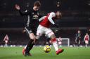 Manchester United's Victor Lindelof (left) and Arsenal's Alexandre Lacazette battle for the ball during the Premier League match at the Emirates Stadium, London.