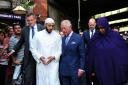 Prince Charles speaks to Imam Mohammed Mahmoud as they walk under the Seven Sisters Road bridge towards Muslim Welfare House. Picture: David Mirzoeff/PA