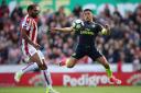 Arsenal's Alexis Sanchez (right) and Stoke City's Glen Johnson battle for the ball (pic Nick Potts/PA)