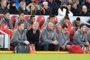 Arsenal manager Arsene Wenger (second left) in the dugout during the Premier League match at Anfield, Liverpool.