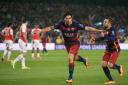 Barcelona's Luis Suarez (centre) celebrates scoring their second goal against Arsenal with team-mate Jordi Alba