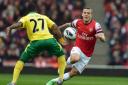 Norwich's Alex Tettey in action against Jack Wilshere. Photo: Anthony Devlin/PA