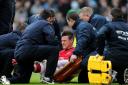 Arsenal's Laurent Koscielny is treated on the pitch after picking up an injury