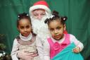 Pictured with Santa in his Grotto from left is Tesuem Hassan 4, Lydia menker 3Pic: Dieter Perry