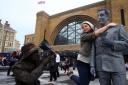 Victorian-themed living statues greeted commuters this morning to mark the opening of the newly redeveloped Kings Cross Square in central London. PRESS ASSOCIATION Photo. Picture date: Thursday September 26, 2013. The 15 familiar faces from Londons street