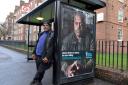 Errol McKellar stands next to his photo, which appears on an awareness advertisment for Prostate Cancer UK at Bus Stop K in Pembury Road. Picture: Polly Hancock