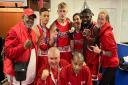 Islington Boxing Club\'s John \'JR\' Richards (coach), Kai Brown, Ethan Frost, Amy Joseph, Elliot Elimasi and Ailsa Mullins (coach) face the camera with coaches Roy Callaghan and Jerry Mitchell (kneeling).