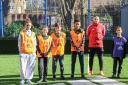 Coach Kai Brennan and young people at the refurbished Harvist Estate pitch