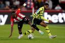 Arsenal's Reiss Nelson battles for the ball at Brentford