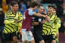 Referee Jarred Gillett is surrounded by players after disallowing a late Arsenal goal at Aston Villa