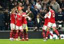 Arsenal players celebrate after Martin Odegaard's goal put them 2-0 up at Tottenham