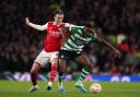 Arsenal's Rob Holding (left) and Sporting Lisbon's Dario Essugo battle for the ball at the Emirates