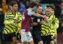 Referee Jarred Gillett is surrounded by players after disallowing a late Arsenal goal at Aston Villa