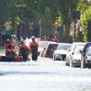 London Fire Brigade ferry local residents along Hornsey Road after water pipe burst