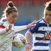 Arsenal's Kim Little (left) and Reading's Angharad James battle for the ball during the FA Women's Super League match at Madejski Stadium