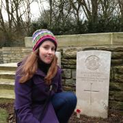 Reporter Beth Wyatt at the grave of her great-great uncle Sidney Stone, in the Somme. Picture: Erica Spurrier/Equity