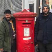 Tara and Ammar from Highgate Stationers next to the post box in the High Street