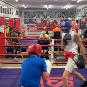 Coach Roy Callaghan oversees sparring in one ring whilst Lenny Hagland supervises the other at Islington Boxing Club
