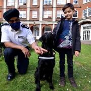 Camden and Islington's head of police, Chief Superintendent Raj Kohli (left), and eight-year-old hospital visitor Stefan Jenner - with PD Dexter