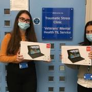 Trauma and stress clinic assistant psychologists Abbie and Noor with the tablets donated by Asda and Helpforce. Picture: C and I NHS Trust