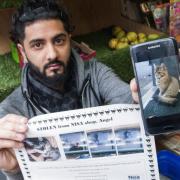 Nisa in Islington had its pet cat Bella stolen. 
Pictured, shop owner Haseeb Kashmiri with a photograph of Bella and a 'missing' poster. Picture: Nigel Sutton