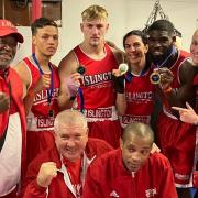 Islington Boxing Club\'s John \'JR\' Richards (coach), Kai Brown, Ethan Frost, Amy Joseph, Elliot Elimasi and Ailsa Mullins (coach) face the camera with coaches Roy Callaghan and Jerry Mitchell (kneeling).