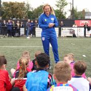 England manager Sarina Wiegman talks to youngsters on the day of her World Cup squad announcement