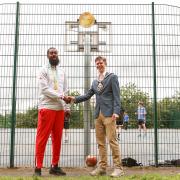Orlan Jackman and Mayor of Haringey Cllr Lester Buxton pose by his Golden Gateways plaque at Finsbury Park basketball courts