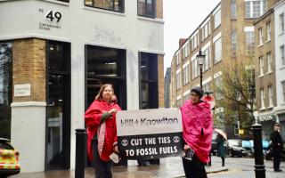 Two Extinction Rebellion activists outside the offices of Hill and Knowlton Strategies